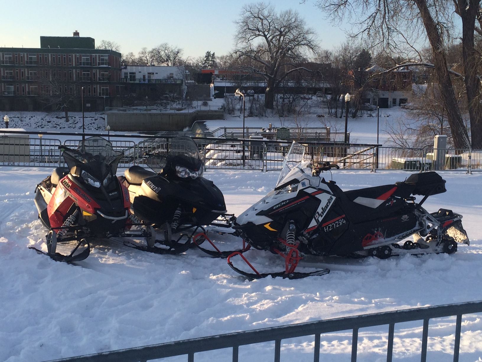 Three Snowmobiles Parked by Each Other